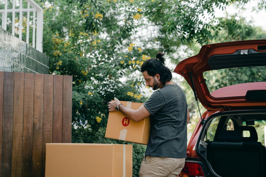 Man brings emergency rations from the car to the warehouse